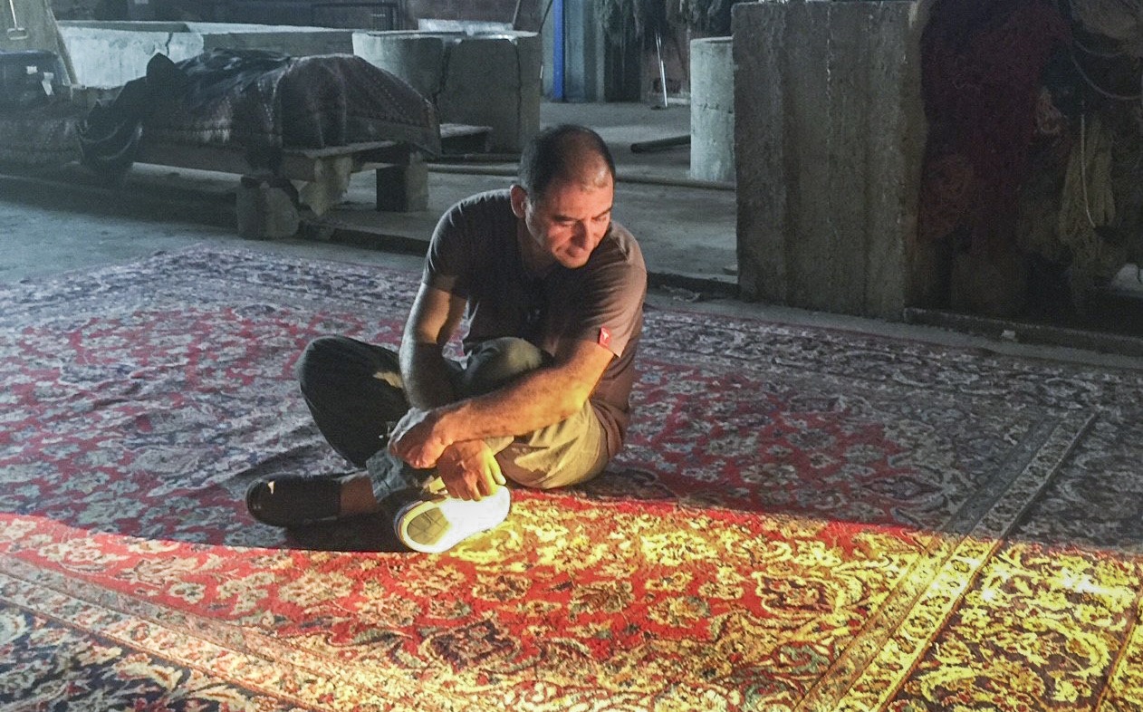the rug bazaar inspecting rug